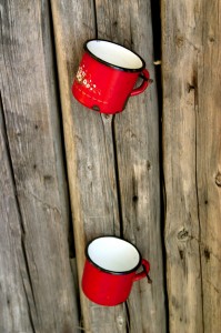 Metal red mugs on the wood wall